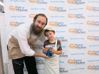 Ben Snukal with his full Pushka that he brought from his home in the Hashmonaim,West Bank to be donated to Colel Chabad, Jerusalem